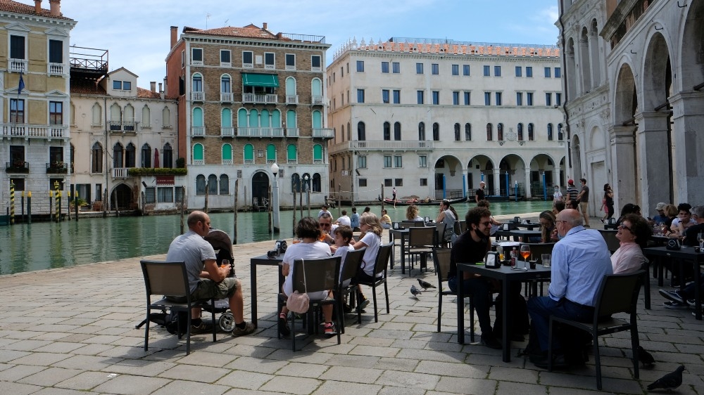 Tourists have lunch at a restaurant by the Grand Canal following the outbreak of the coronavirus in Venice, Italy