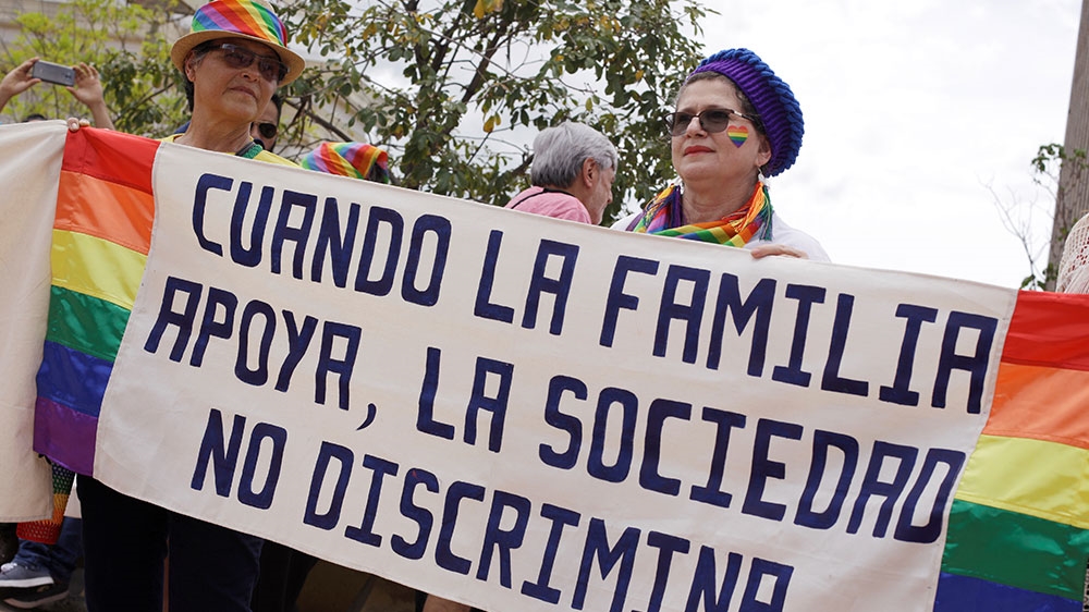 LGBT community members and activists demonstrate in front of the Supreme Court of Justice with a sign that reads ‘when the family supports, society does not discriminate’