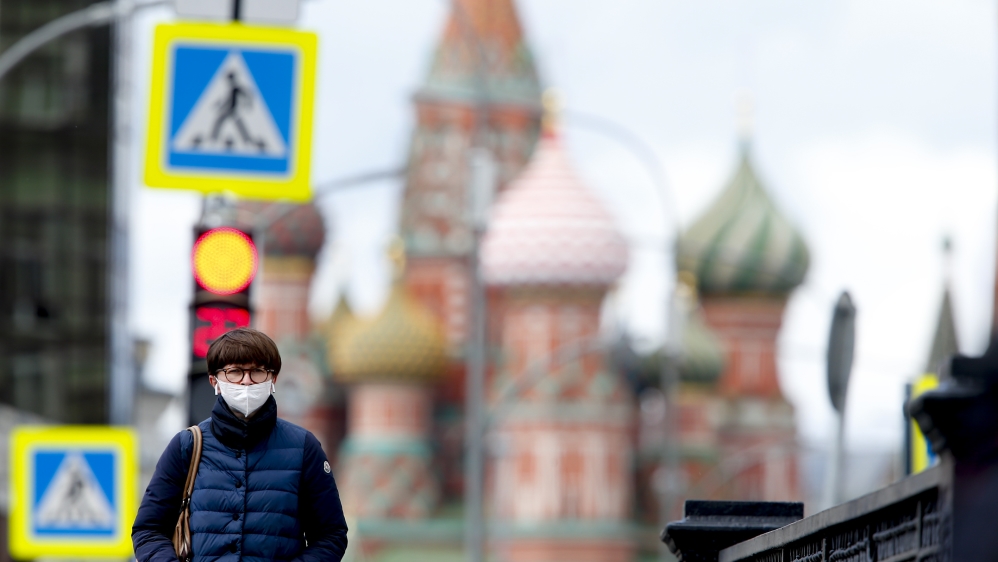 A woman wears a mask as a precaution against coronavirus as she walks at Pyatnitskaya street in Moscow [EPA]