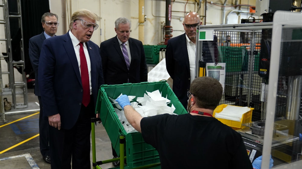 President Donald Trump participates in a tour of a Honeywell International plant that manufactures personal protective equipment, while not wearing any