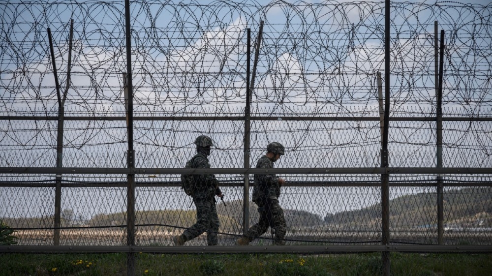 South Korean soldiers patrol the Demilitarized Zone (DMZ), which separates North and South Korea, The two countries announced the restoration of communication links in a surprise thaw in tense relations