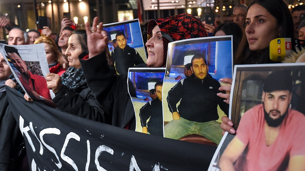 After the attack, mourners held up photos, believed to be of victims, during a vigil close to the crime scene in Hanau, near Frankfurt