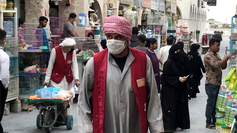 A man wears a protective face mask as he pushes a cart in souq Waqif in Doha, Qatar at the beginning of the outbreak[Reuters]