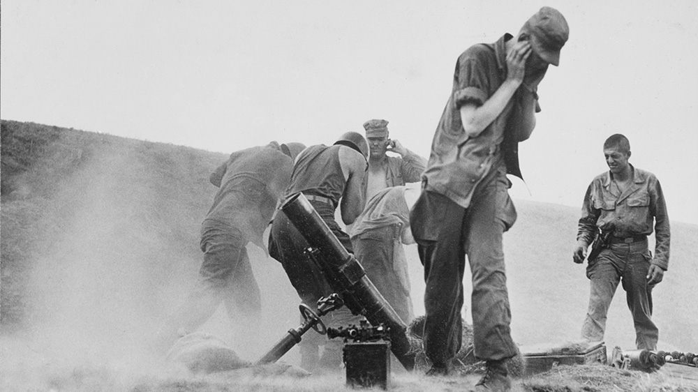 United Nations forces hold their ears while firing mortars at Communist positions on the Naktong River front in South Korea, in August 1950. The Korean War began on June 25, 1950 when North Korean troops crossed the 38th parallel into the South