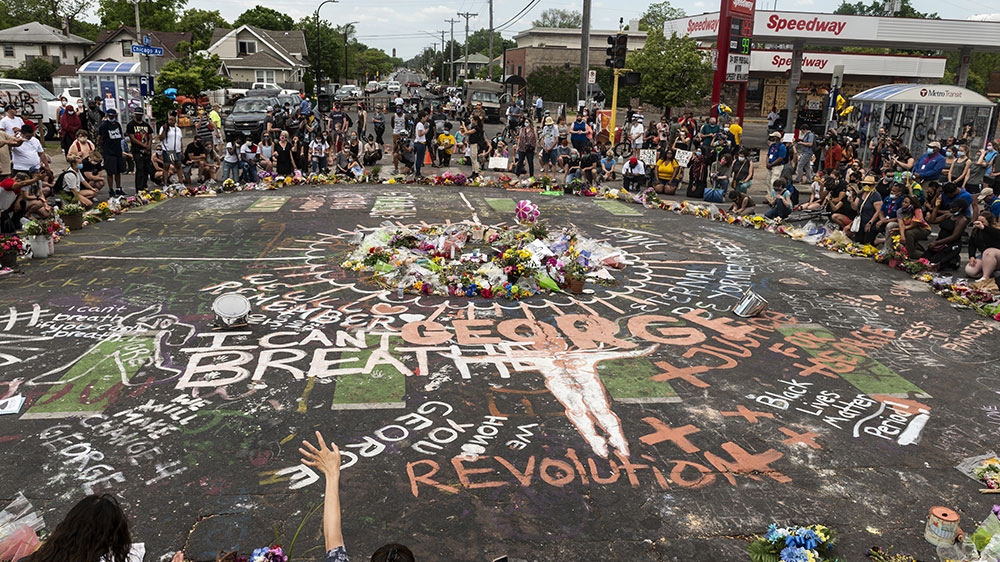 People gather at site where George Floyd died on May 25 while in police custody in Minneapolis, Minnesota