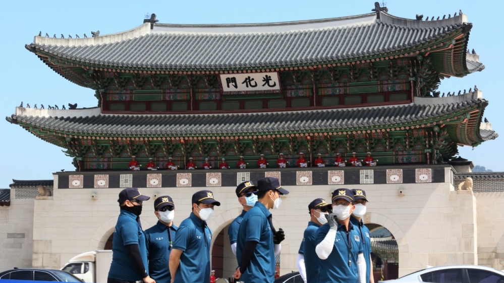 South Korean police officers stand guard during an event to commemorate the upcoming 70th anniversary of the Korean War, near the entrance of the 14th-century Gyeongbok Palace is Seoul