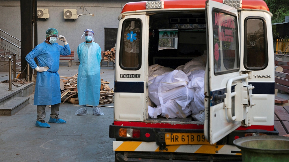 Mohammad Aamir Khan waits for the relatives to unload the bodies of people who died due to the coronavirus disease for their cremation at a crematorium in New Delhi