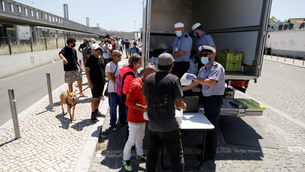 Members of the Portuguese navy distribute meals to people in need amid the coronavirus outbreak, in Lisbon, Portugal