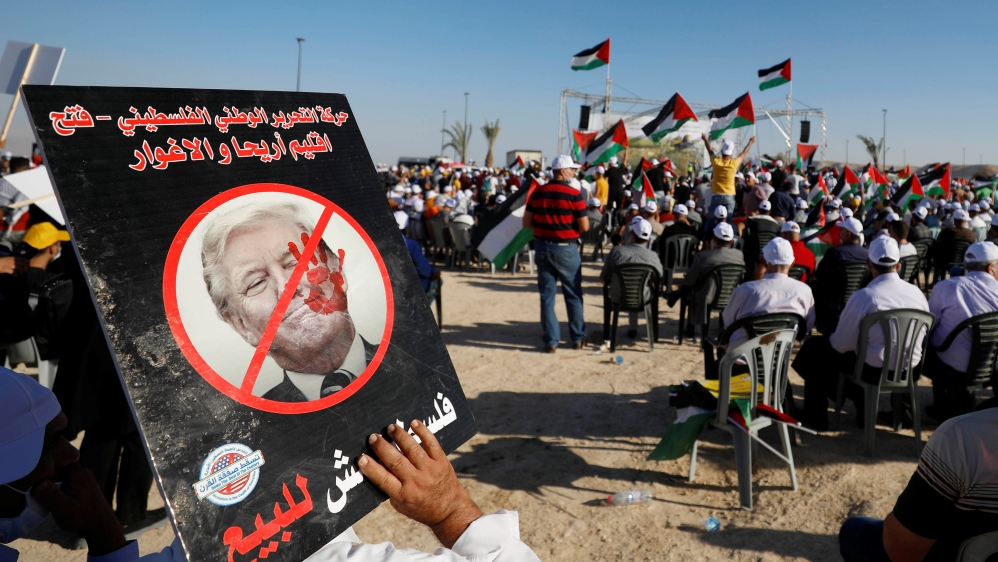 A demonstrator holds an anti-Trump placard during a rally to protest against Israel’s plan to annex parts of the occupied West Bank