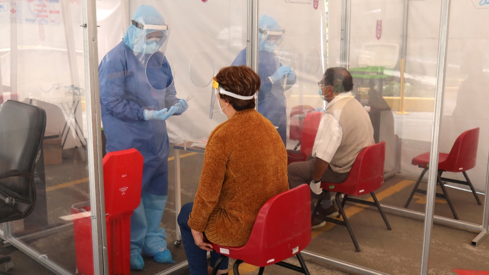 Members of biological sciences of the National Polytechnic Institute in Mexico City test people for COVID-19