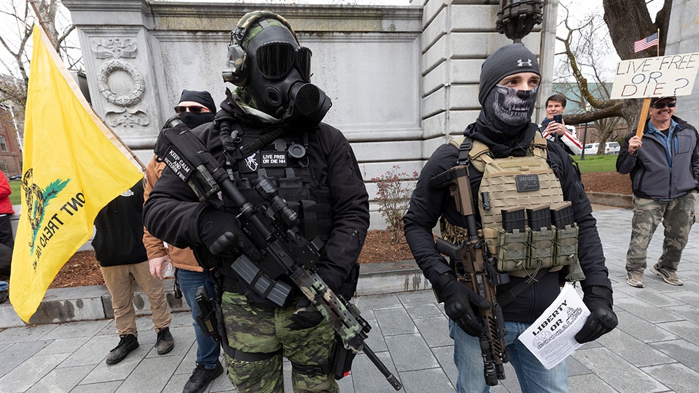 Members of the “Boogaloo” movement, attend a demonstration against the coronavirus lockdown in Concord, New Hampshire