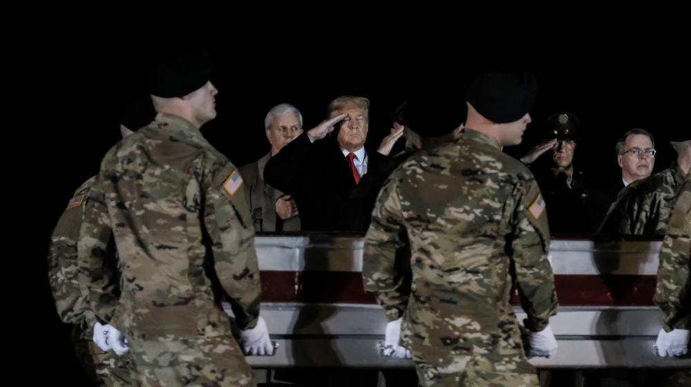 U.S. President Donald Trump salutes during the dignified transfer of the remains of U.S. Army soldiers SFC Javier Jaguar Gutierrez and SFC Antonio Rey Rodriguez, who were killed in Nangarhar province