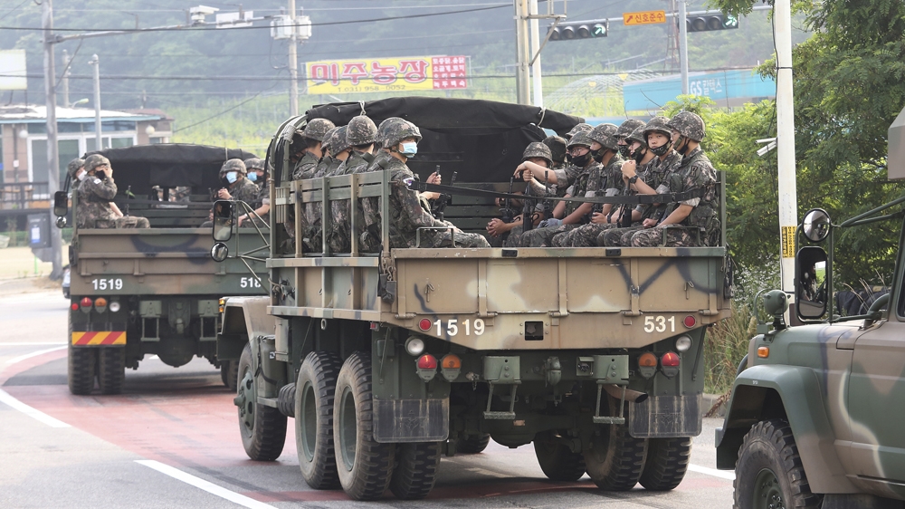 South Korean army soldiers on the back of trucks in Paju, near the border with North Korea on Wednesday amid rising tensions between the two countries