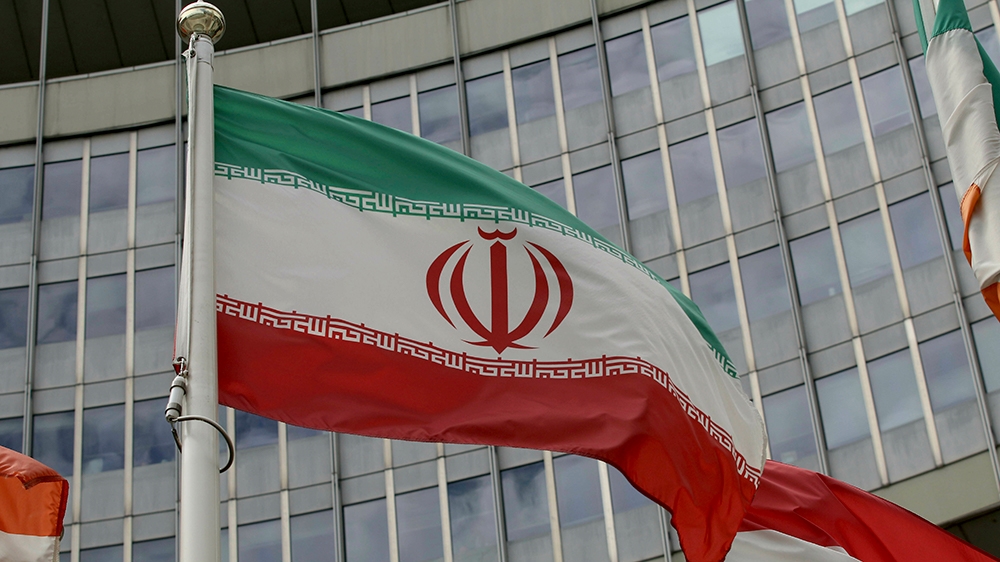 The Iranian flag waves outside of the UN building that hosts the International Atomic Energy Agency, IAEA, office inside in Vienna, Austria, Wednesday, July 10, 2019. (AP Photo/Ronald Zak)