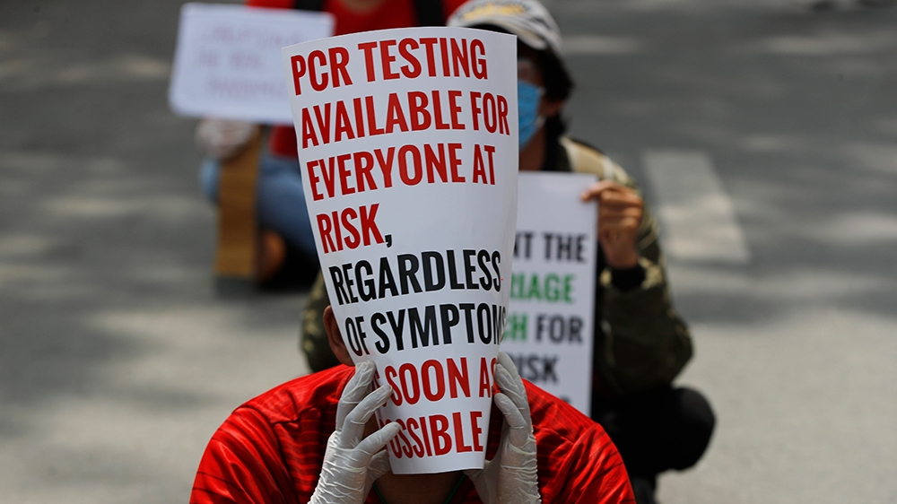 Hundreds of protesters gathered demanding increased testing and alleging corruption by government officials while buying equipment and testing kits