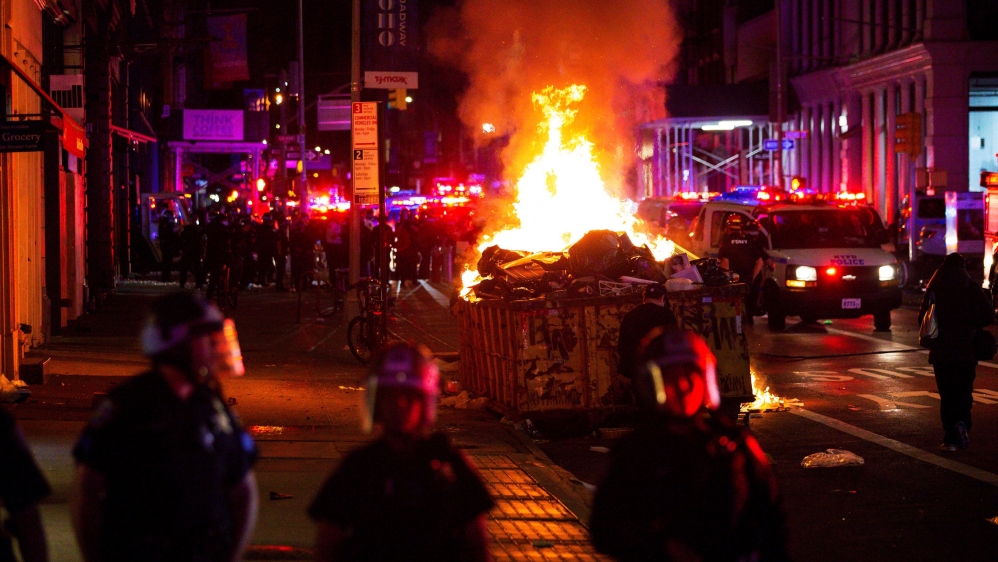 A pile of burning rubbish set by demonstrators is seen during looting after marching against the death in Minneapolis police custody of George Floyd, in the Manhattan borough of New York City