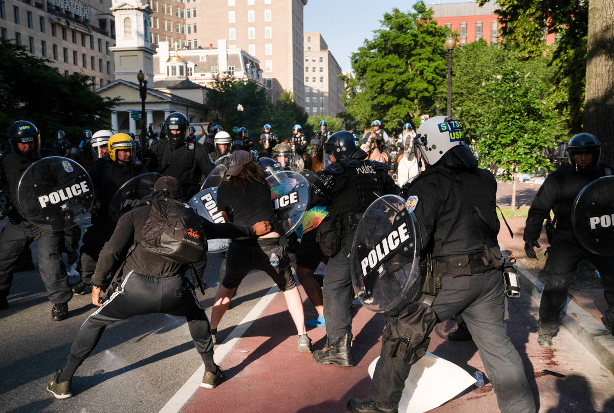 Riot police rush protesters to clear Lafayette Park and the area around it across from the White House before then-President Donald Trump walked through for a photo opportunity in front of St John’s Episcopal Church near the White House in Washington, DC, on June 1, 2020
