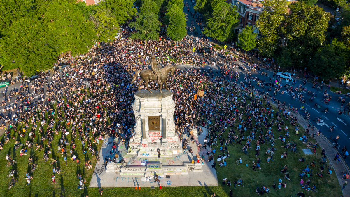 A group of protesters gather around the statue of Confederate General Robert E. Lee on Monument Avenue Tuesday Jun. 2, 2020, in Richmond, Va. The crowd protesting police brutality chanted "Tear it dow