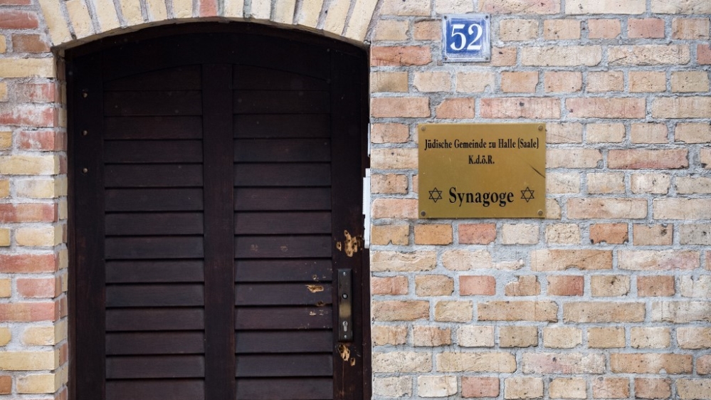 The synagogue’s heavy wooden door still bears the bullet holes from the assault
