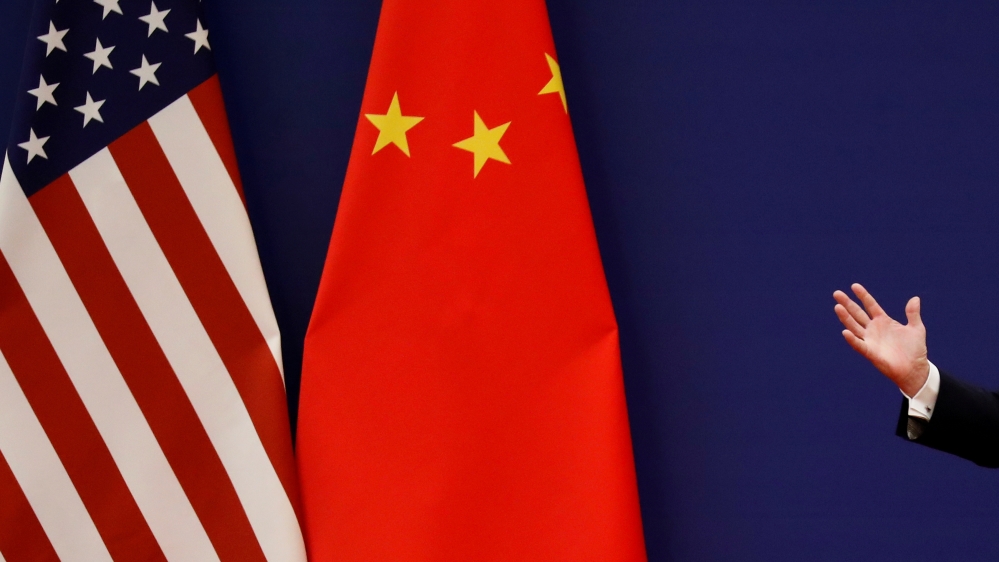 FILE PHOTO: U.S. President Donald Trump delivers his speech as he and China''s President Xi Jinping meet business leaders in Beijing