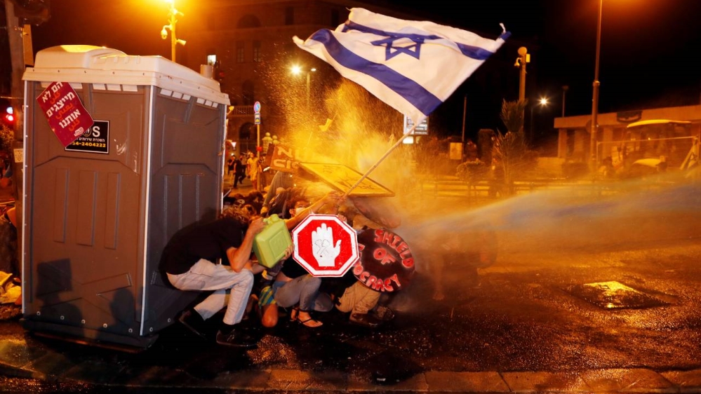 Police use water cannon during a protest against Israeli Prime Minister Benjamin Netanyahu’s alleged corruption and his government’s handling of the coronavirus disease crisis, near his residence in Jerusalem early on Sunday