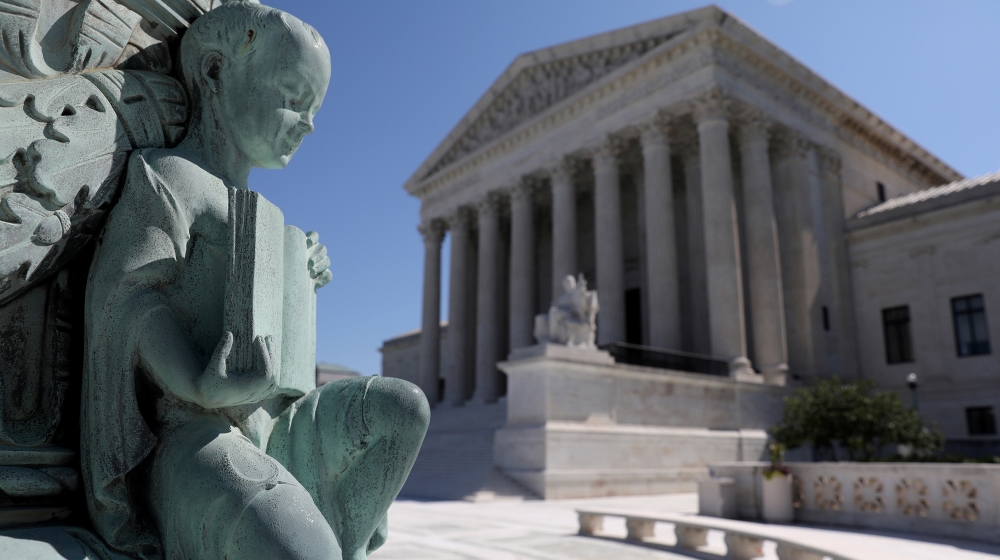 A cherub figure with a book, symbolizing learning, is seen in a general view of the U.S. Supreme Court building in Washington, U.S. July 2, 2020. REUTERS/Jonathan Ernst/File Photo