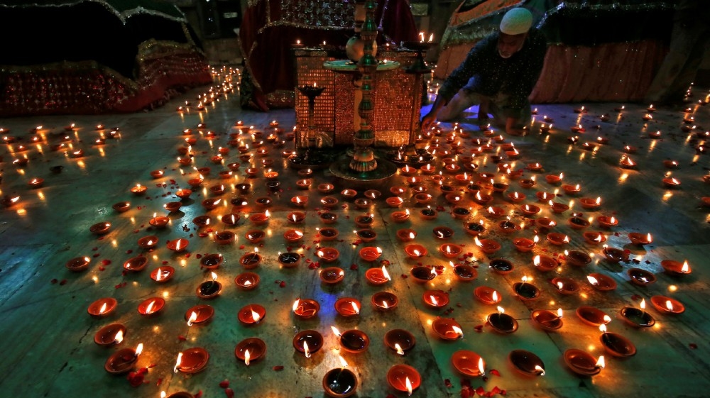 A man lights an oil lamp inside the tomb of Ahmad Shah during a special prayer meeting for the victims of the coronavirus disease (COVID-19), amid the spread of the disease in Ahmedabad, India