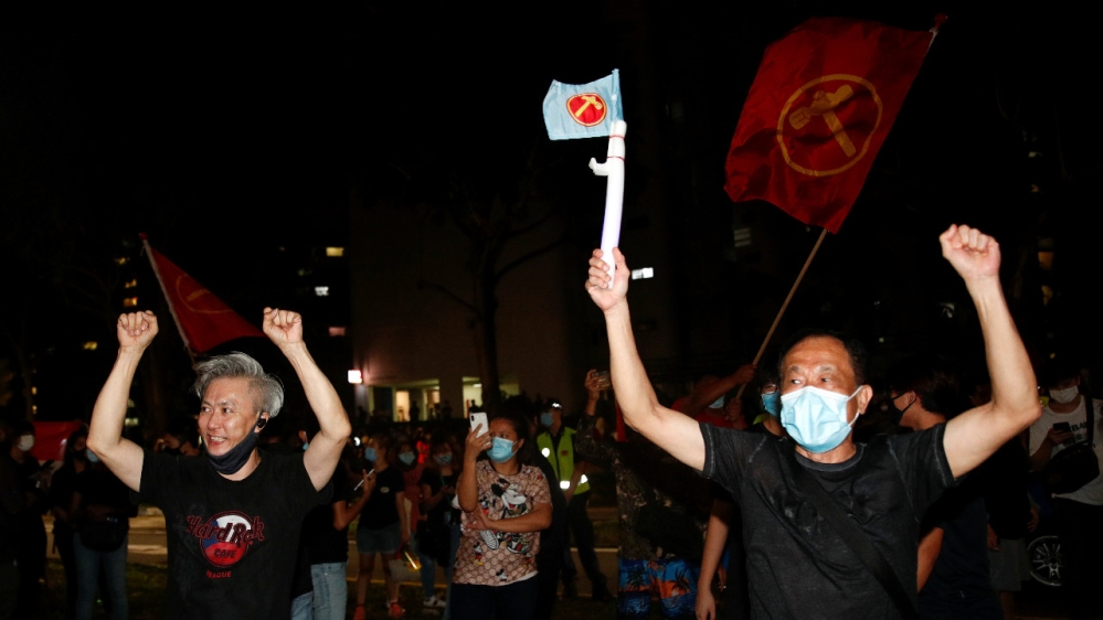Workers’ Party supporters celebrate the results of the general election in Singapore on July 11