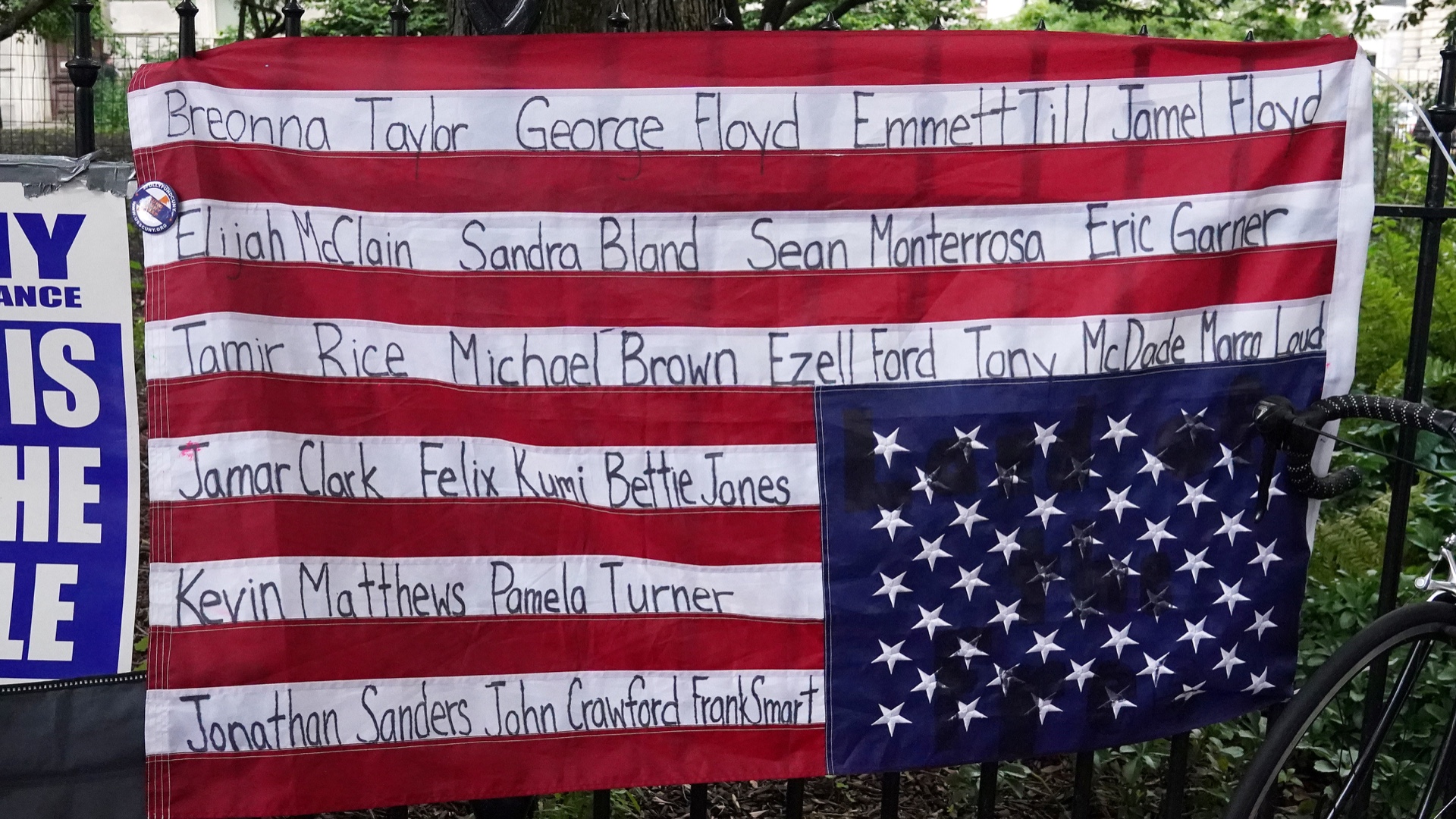 An upside down US flag with the names of Black people killed by police hangs in New York City [Reuters]