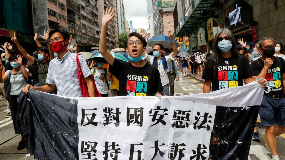 Pan-democratic legislator Eddie Chu Hoi-dick, Vice convener for Hong Kong''s Civil Human Rights Front Figo Chan and activist Leung Kwok-hung march at the anniversary of Hong Kong''s handover to China