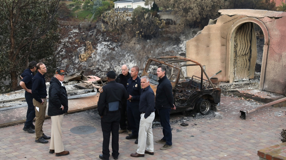 Donald Trump surveyed homes destroyed by fires with Gavin Newsom, first responders and Jerry Brown in Malibu in November 2018 [Reuters]