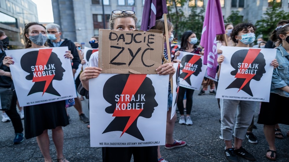 Protesters hold banners reading ‘Let us live’ and ‘Women’s Strike’ during Friday’s demonstration in the capital, Warsaw