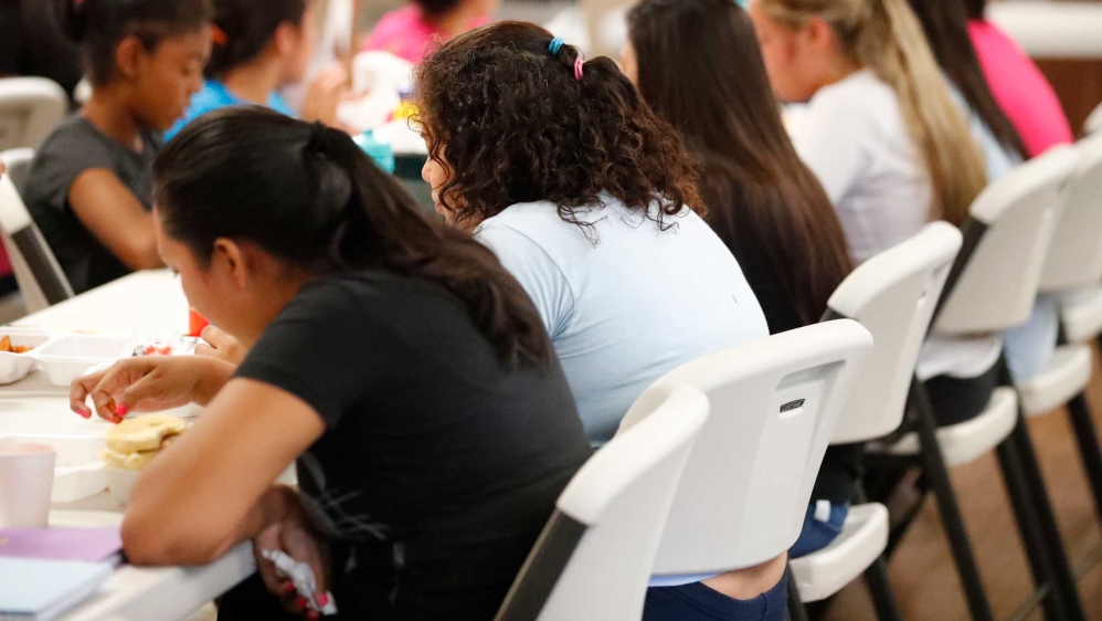 Girls eating lunch at a shelter for migrant teenage girls, in Lake Worth, Florida