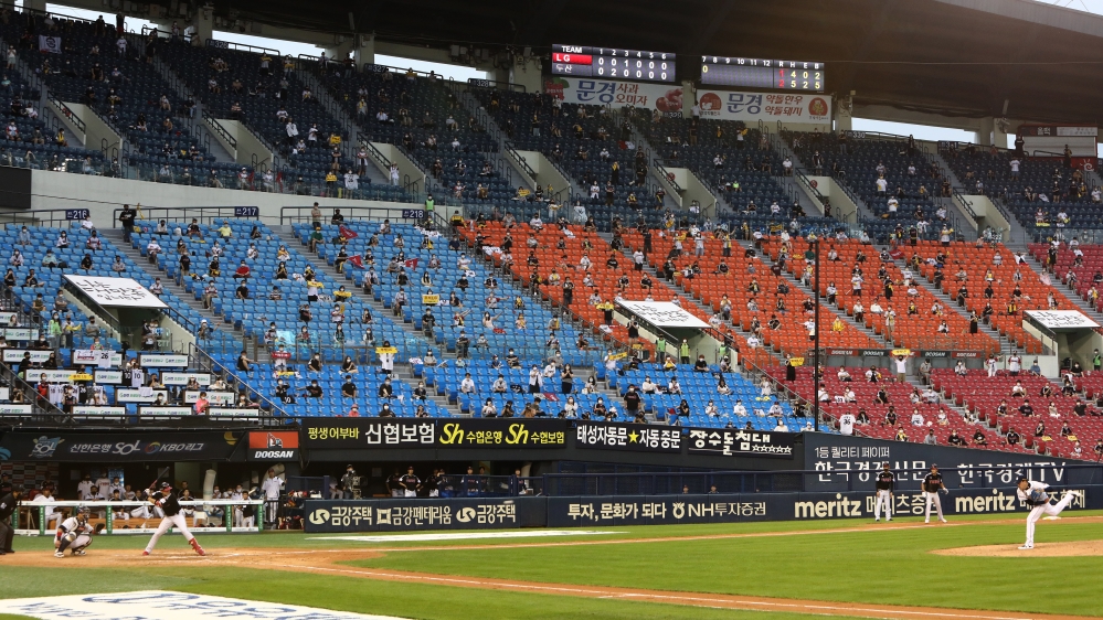 Baseball fans enjoy the Korea Baseball Organization League game between the LG Twins and Doosan Bears at the Jamsil Stadium in Seoul, South Korea
