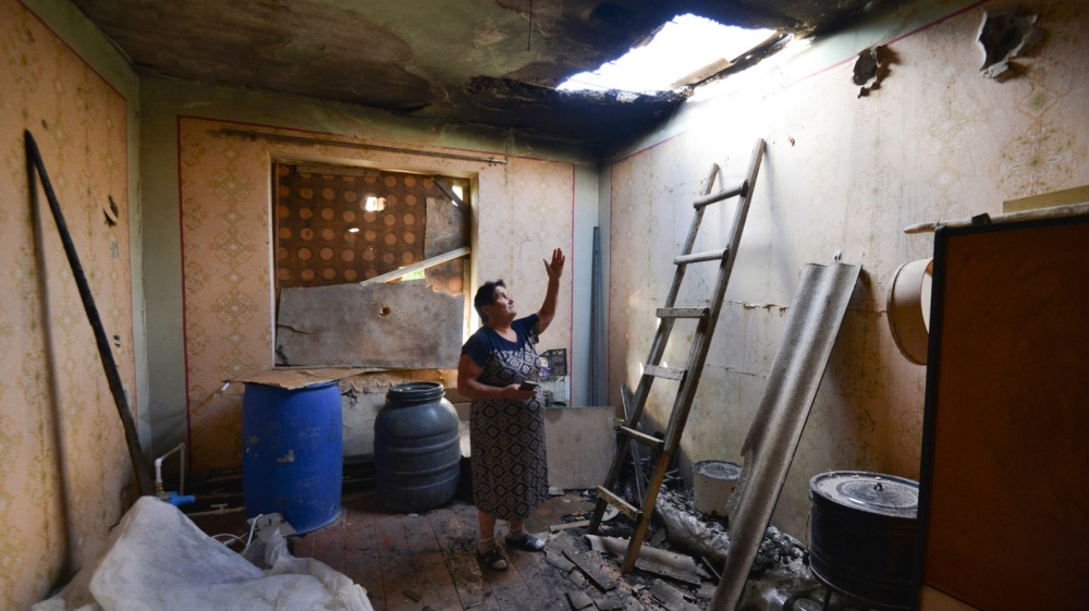 A local woman shows damage in her house after the shelling by the Azerbaijan side in the Aygepar village in Armenia''s Tavush region, Armenia, Wednesday, July 15, 2020. Three days of fighting between A