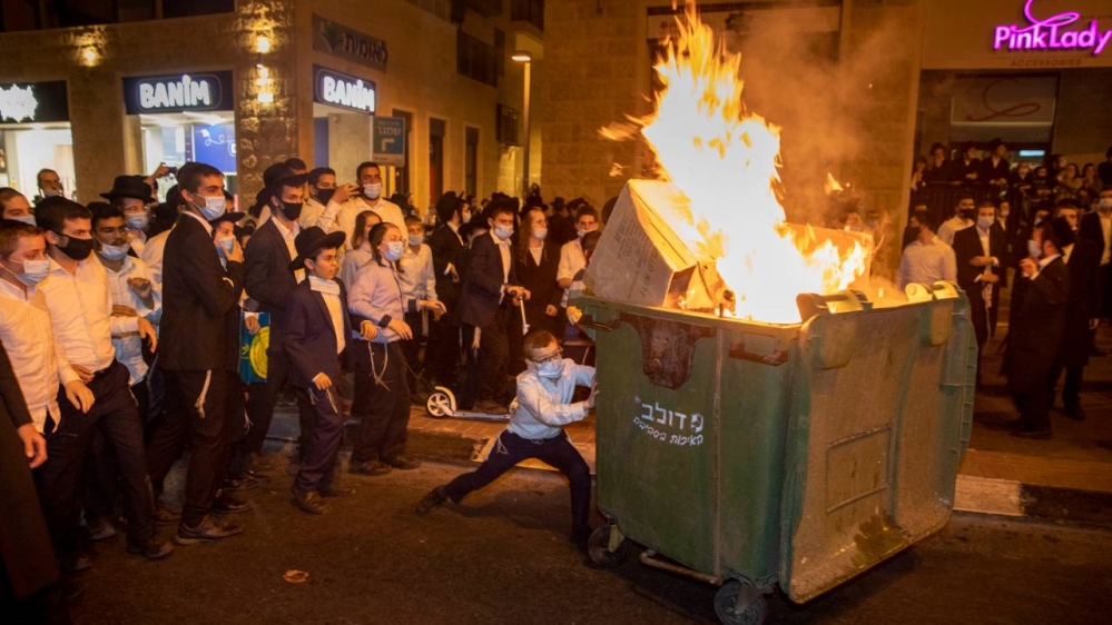 Ultra-Orthodox Jews burn a dumpster during a protest against lockdown in Jerusalem on Monday