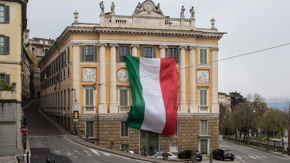 A giant Italian national flag hanging over the facade of Palazzo Medolago Albani near Milan