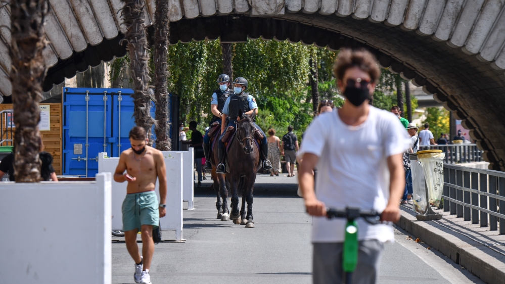 People wear masks in Paris as government takes new measures against the coronavirus