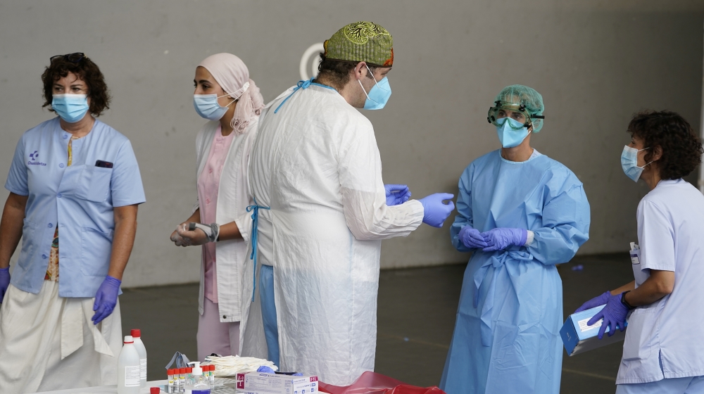 A medical team prepare to administer PCR tests to residents of the Basque town of Azpeitia, Spain, amid a localised outbreak of the coronavirus disease (COVID-19), August 17, 2020. REUTERS/Vincent Wes