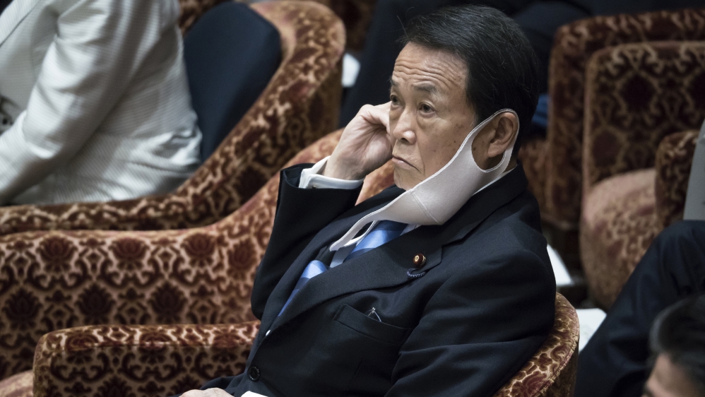Japan’s Deputy Prime Minister and Minister of Finance Taro Aso wearing a face mask attends a budget committee meeting at the lower house of Parliament in Tokyo, Japan