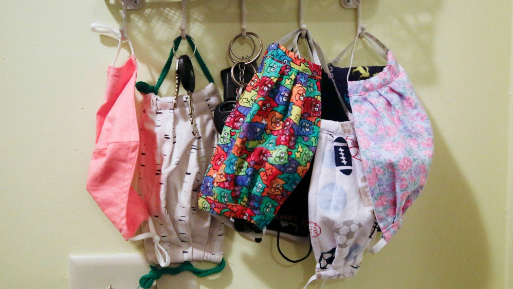 Face masks hang on hooks along with keys by the front door of the Adamus family home, in Dallas, Georgia