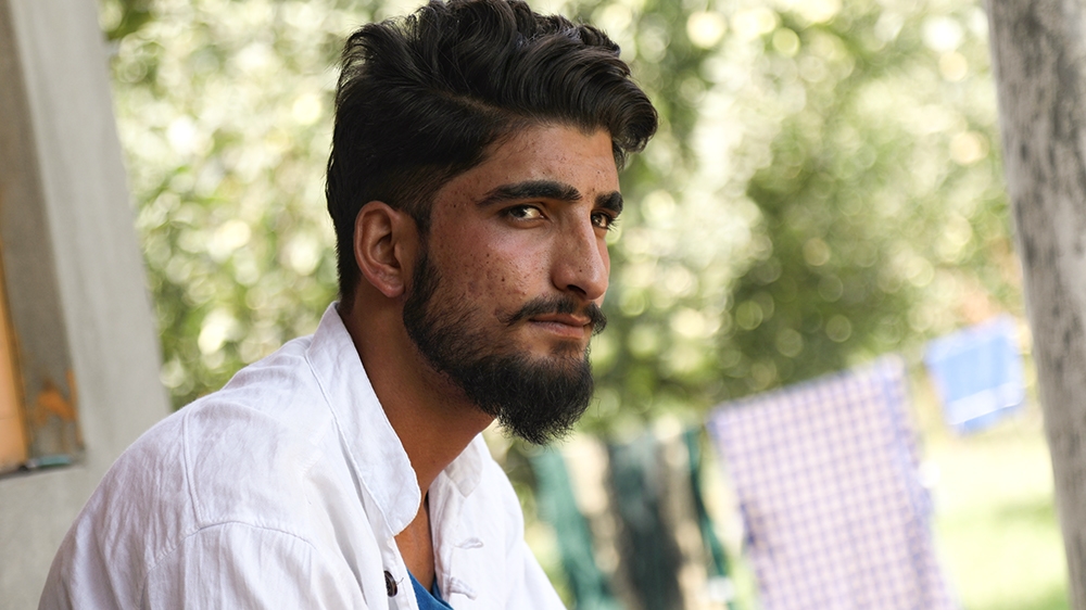 Shariq Ahmad, who was hit with pallets last month, sitting at his home