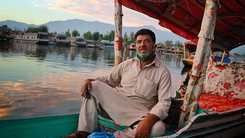 Abdul Majeed sitting on his boat at Dal lake in Srinagar