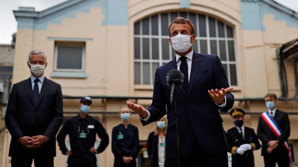 French President Emmanuel Macron, wearing a protective face mask, delivers a speech as he visits a site of pharmaceutical group Seqens, a global leader on the production of active pharmaceutical ingredients