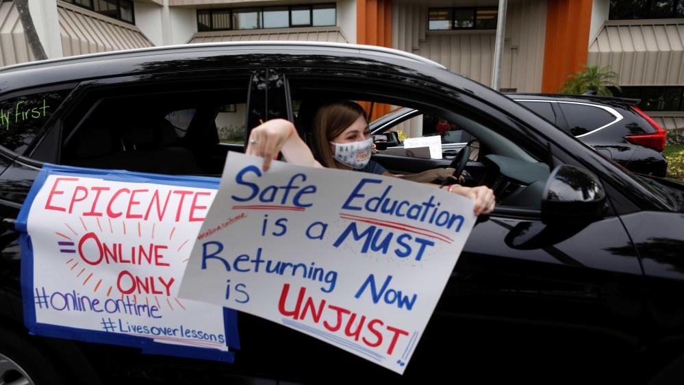 Florida teachers, whose unions are against their members returning to school, hold a car parade protest in front of the Pasco County School district office in Land O’ Lakes, Florida, US