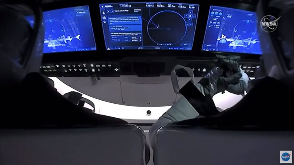 This NASA video frame grab shows SpaceX’s Crew Dragon spacecraft with NASA astronauts Douglas Hurley and Robert Behnken watching on their screens an infrared view of the International Space Station after undocking from it