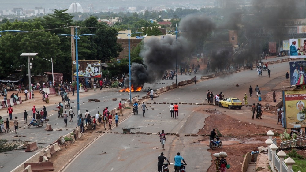 Anti-government protesters burn tires and barricade roads in the capital Bamako on July 10