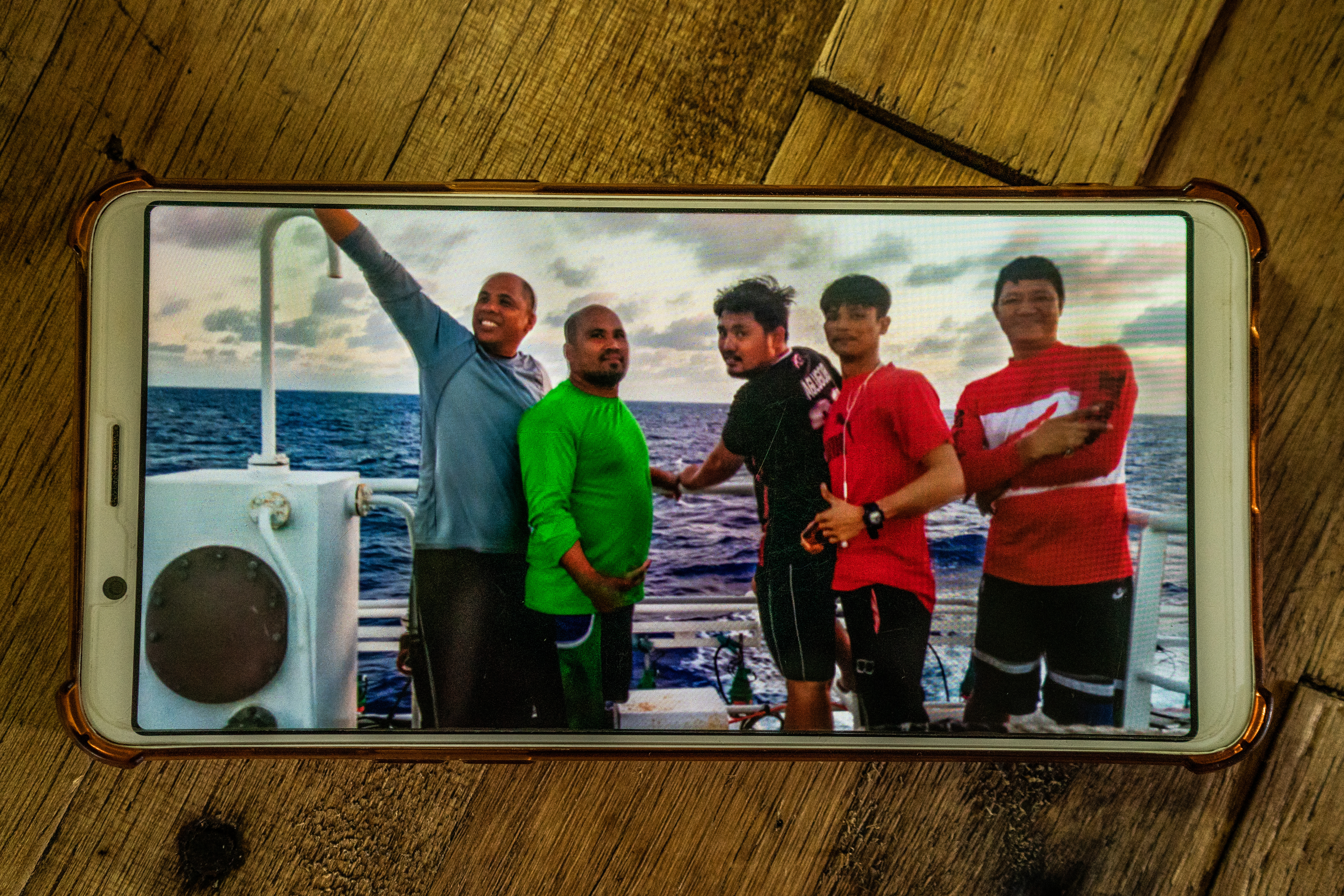 Jesus Gaboni, left, with other Filipino crew on board their fishing vessel. The man on the right, Raul Calopez, got sick onboard and eventually died. Gaboni helped store Calopez’s body in the ship’s freezer where it remains today