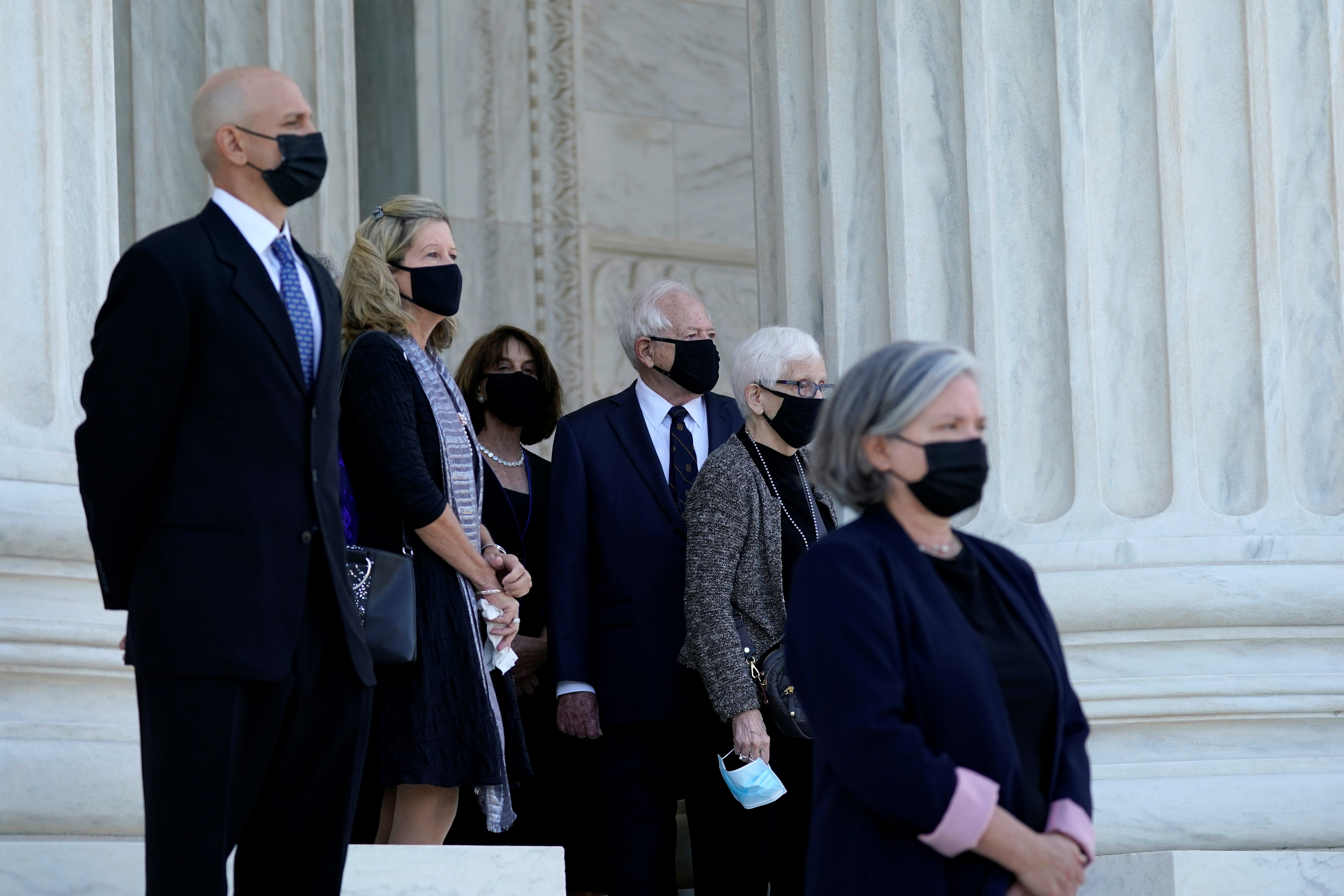 Former US President Jimmy Carter watches as the flag-draped coffin of Justice Ruth Bader Ginsburg arrives at the Supreme Court in Washington, DC, US