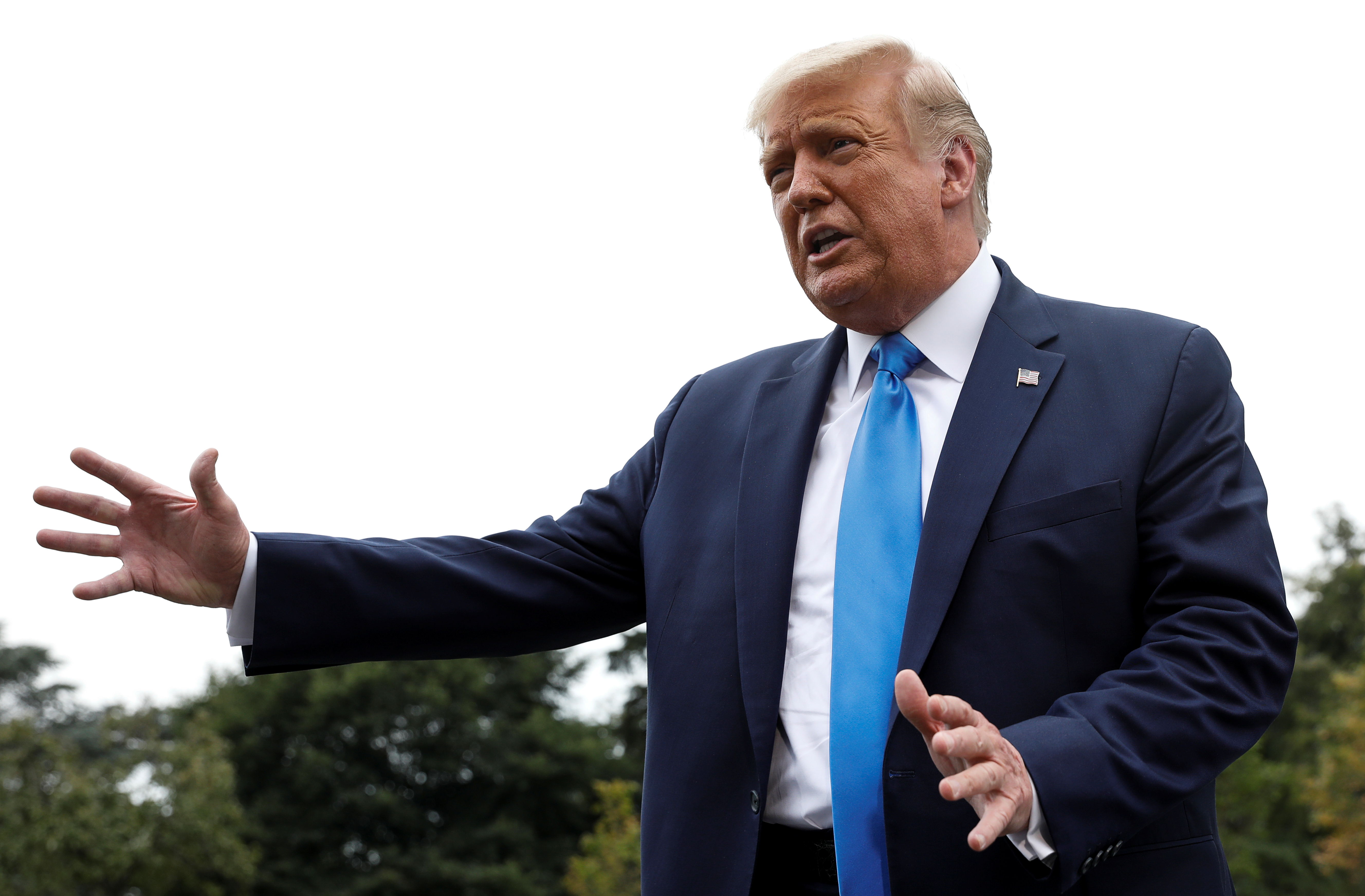 US President Donald Trump talks to reporters as he departs for campaign travel to North Carolina and Florida from the South Lawn at the White House